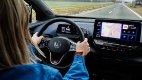 A lady drives her car on a highway