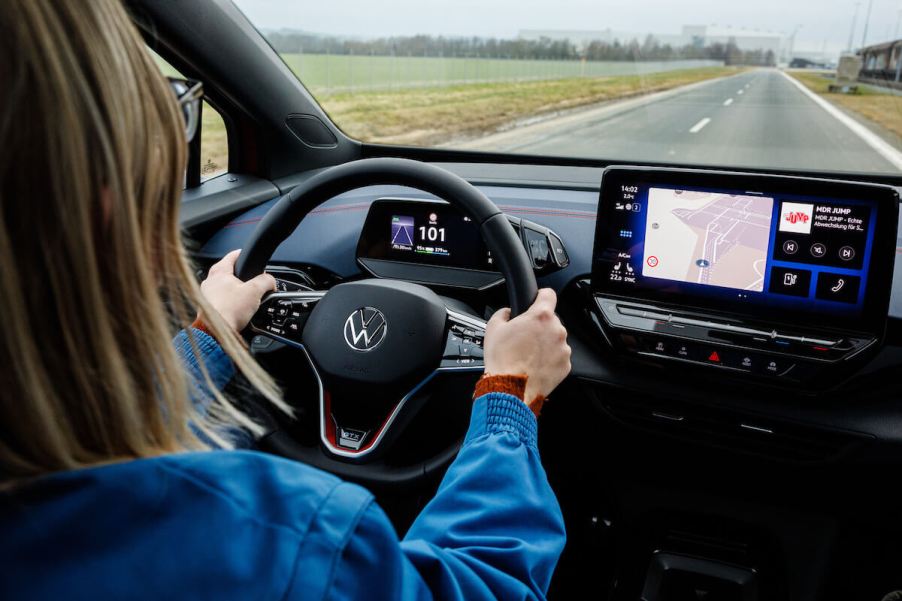 A lady drives her car on a highway