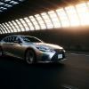 A 2024 Lexus LS 500h full-size hybrid luxury sedan model driving through tunnel with light leaking in