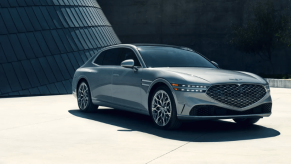 A 2024 Genesis G90 full-size luxury sedan model parked on a concrete plaza