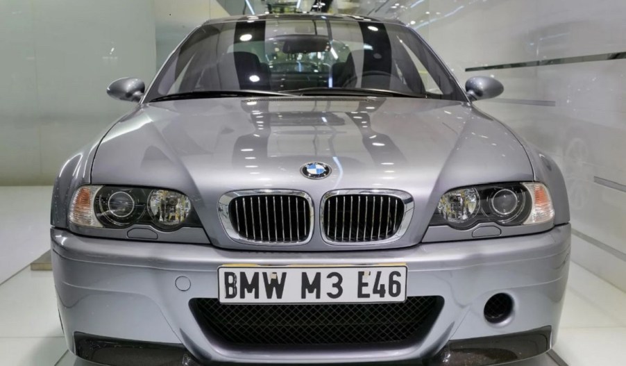 A silver used 2003 BMW E46 M3 CSL front view parked inside an auction house showroom