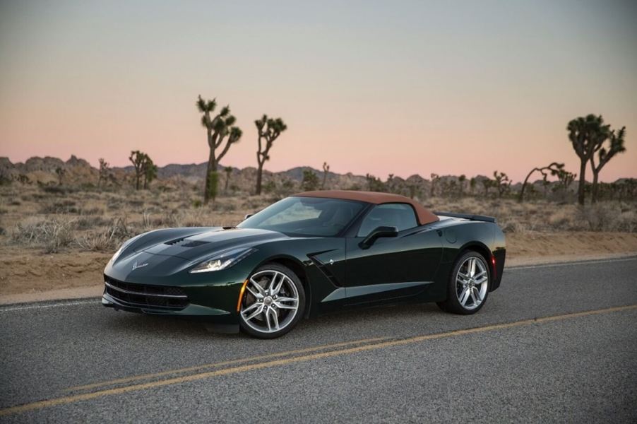 A green C7 Corvette Stingray Convertible sits on a desert road.