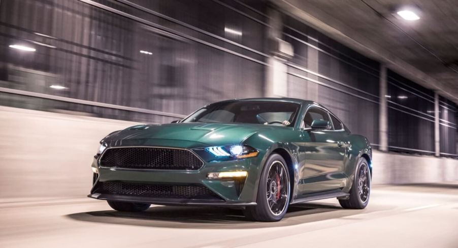 A Dark Highland Green S550 Ford Mustang Bullitt drives through a tunnel.