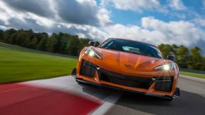 An orange Chevrolet Corvette Z06 tackles a corner on a track.