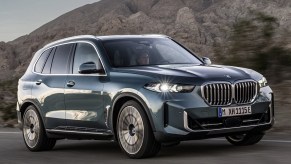 The 2024 BMW X5 driving on the road