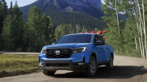 The 2024 Honda Ridgeline driving on a dirt road