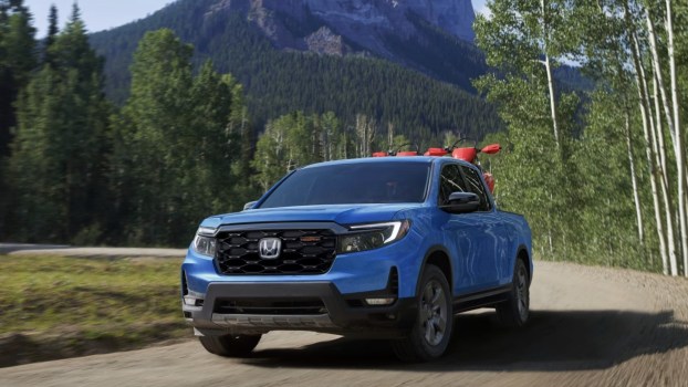 The 2024 Honda Ridgeline driving on a dirt road