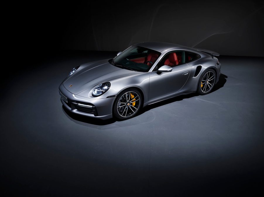 A 2024 Porsche 911 Turbo S sits under an overhead light.