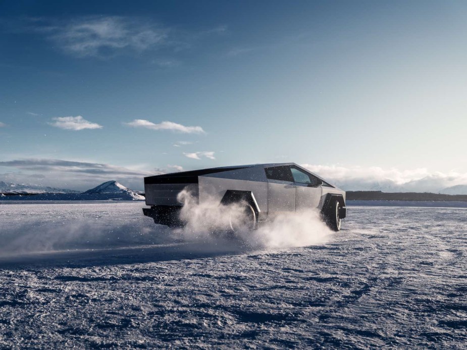 Tesla Cybertruck driving through a desert while off-roading.