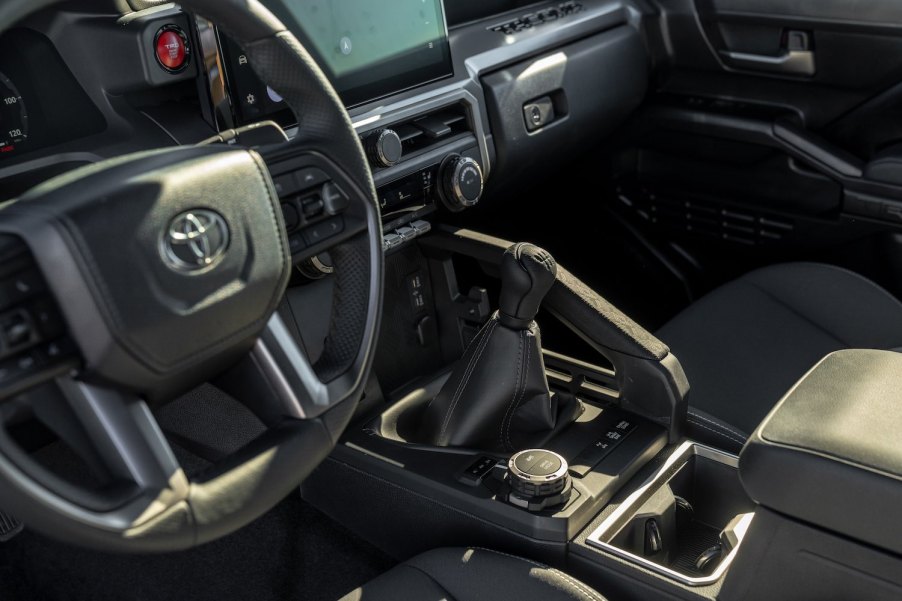 The manual transmission gearshift lever in a 2024 Toyota Tacoma TRD Off Road midsize pickup truck.