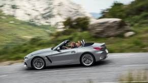 A gray BMW Z4 drives on a mountain road.