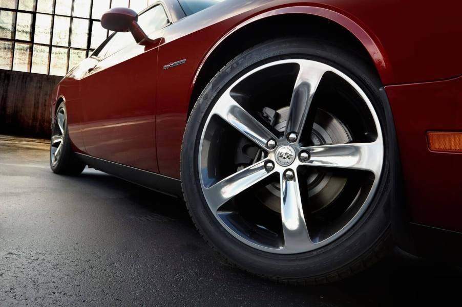 A 2014 Dodge Challenger muscle car shows off its wheels.