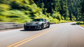 A gray Ferrari 812 Superfast, like Michael B. Jordan's, blasts down a road.