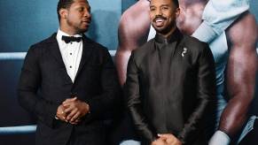 Jonathan Majors and Michael B. Jordan chat at an even promoting 'Creed III'.