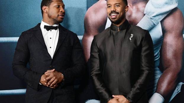 Jonathan Majors and Michael B. Jordan Talk Shop Next To 1 of the Ugliest Luxury SUVs in ‘Creed III’