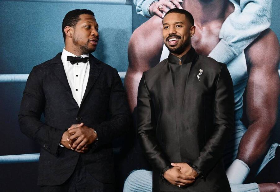 Jonathan Majors and Michael B. Jordan chat at an even promoting 'Creed III'.