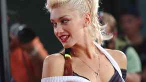 Gwen Stefani is shown at a 2004 movie premier wearing a layered tank top and ponytail