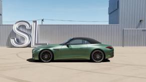 A green 2024 Mercedes-AMG SL 63 S E Performance shows off its side profile.