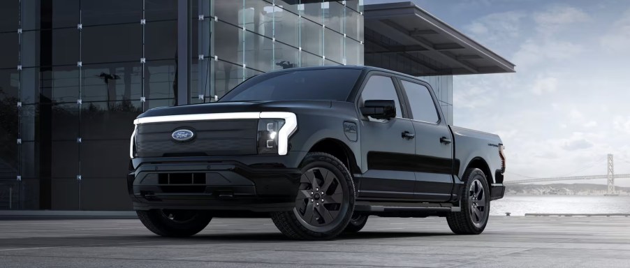 The 2023 Ford F-150 Lightning near a building