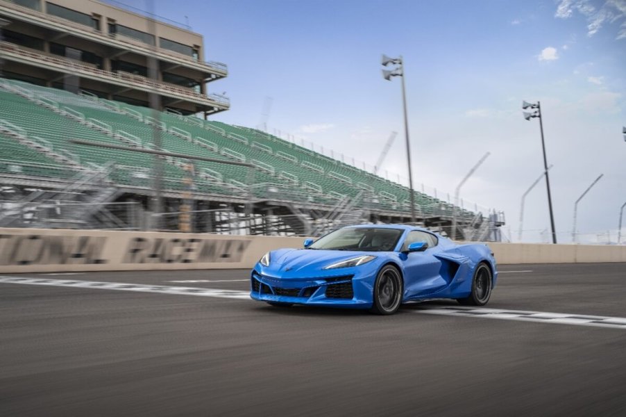 A hybrid 2024 Chevrolet Corvette E-Ray 3LZ crosses a finish line on a track.