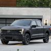 The 2024 Ford F-150 Lightning parked in front of a home