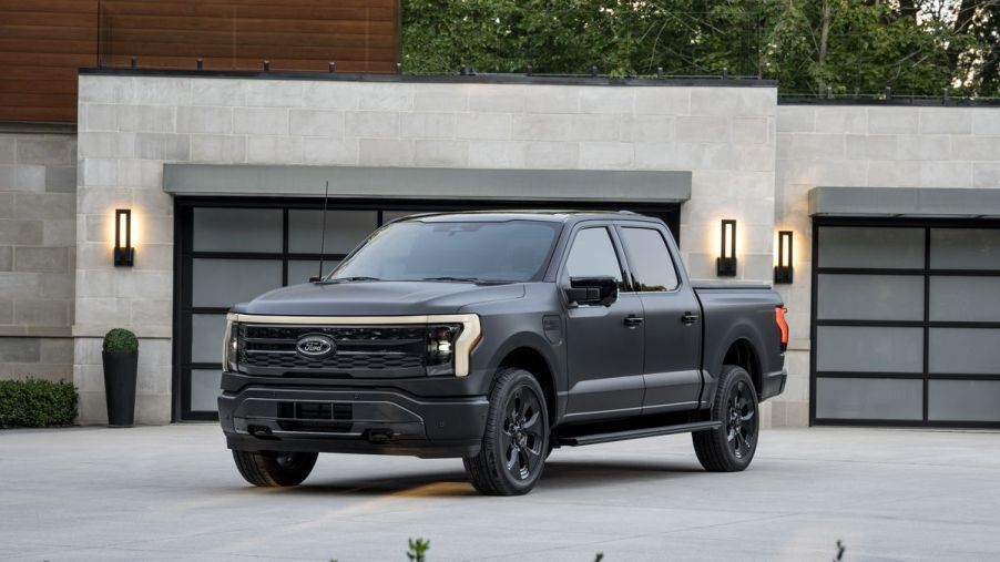 The 2024 Ford F-150 Lightning parked in front of a home