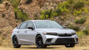 A 2024 Honda Civic shows off its compact car platform on a mountain road.