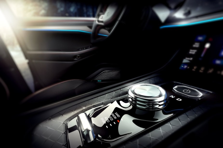 Closeup of the shift knob and other controls in the center console of a Jeep Wagoneer S electric SUV.