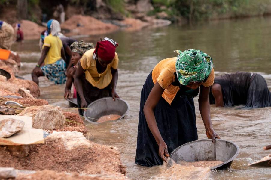 Women pan for precious chemicals in the Congo where lithium is common.