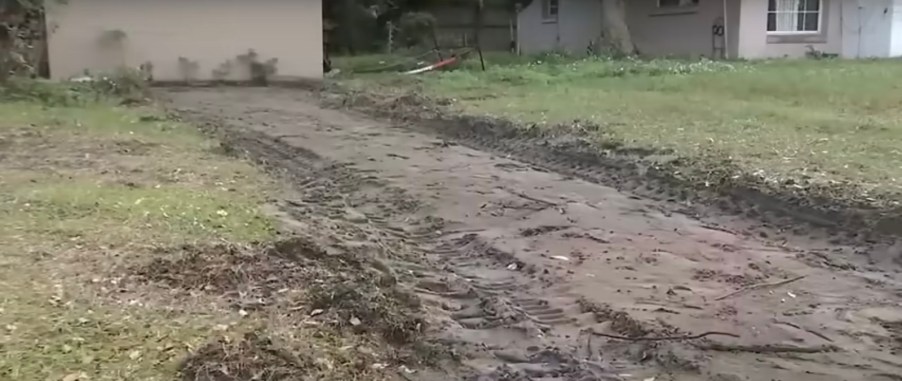 The dirt hole in a Florida woman's lawn, where her driveway once was.