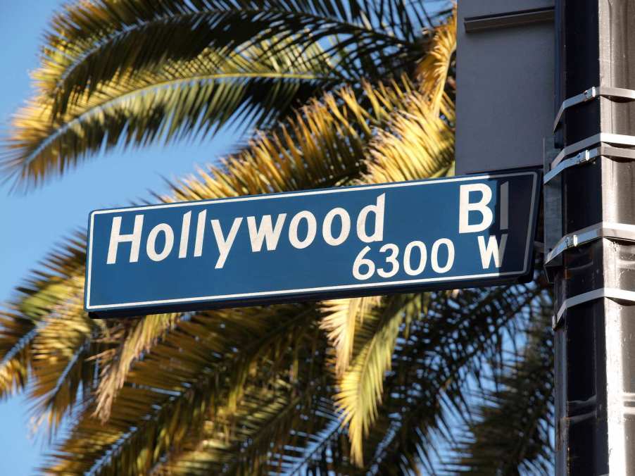 The sign for Hollywood Boulevard, with palm trees in the background.