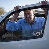 Top Gear and The Grand Tour host Jeremy Clarkson stands by a car door.