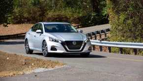 A silver Nissan Altima four-door sedan takes a corner.