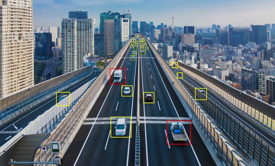 A screenshot of a traffic monitoring system concept highlighting cars on a road.