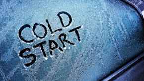 The words "cold start" are drawn on a frozen car window