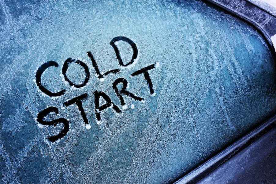 The words "cold start" are drawn on a frozen car window