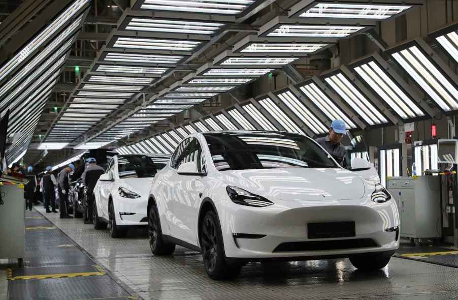 A row of white Tesla cars are shown on the factory floor in Shanghai