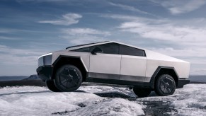 The Tesla Cybertruck parked on rocky terrain