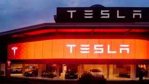 A Tesla showroom with red and white glowing lights at night