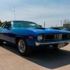 1971 Plymouth Barracuda in a parking lot at a car show.