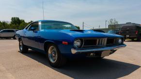 1971 Plymouth Barracuda in a parking lot at a car show.