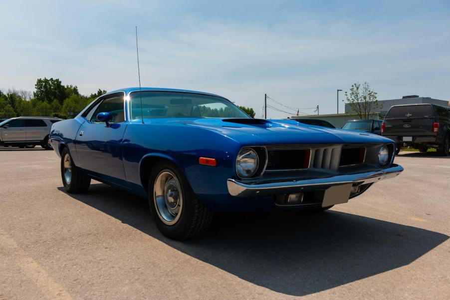 1971 Plymouth Barracuda in a parking lot at a car show.