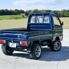 A blue 1993 Honda Acty kei pickup truck shown parked at right rear angle