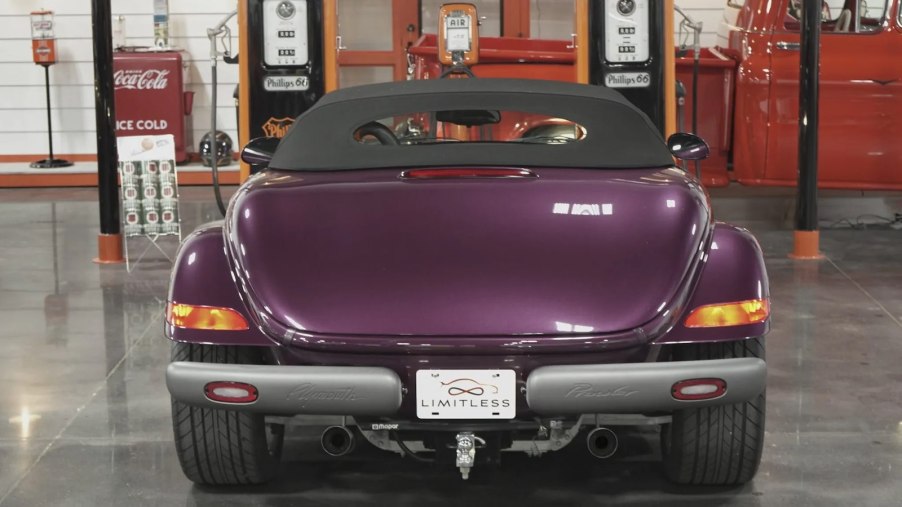 The trunk of a purple Plymouth Prowler parked in a garage.