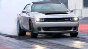 A silver and black 2023 Dodge Challenger SRT Demon 170 on a quarter-mile drag strip.