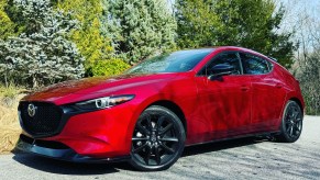 The 2024 Mazda3 Turbo Premium Plus parked near evergreen trees