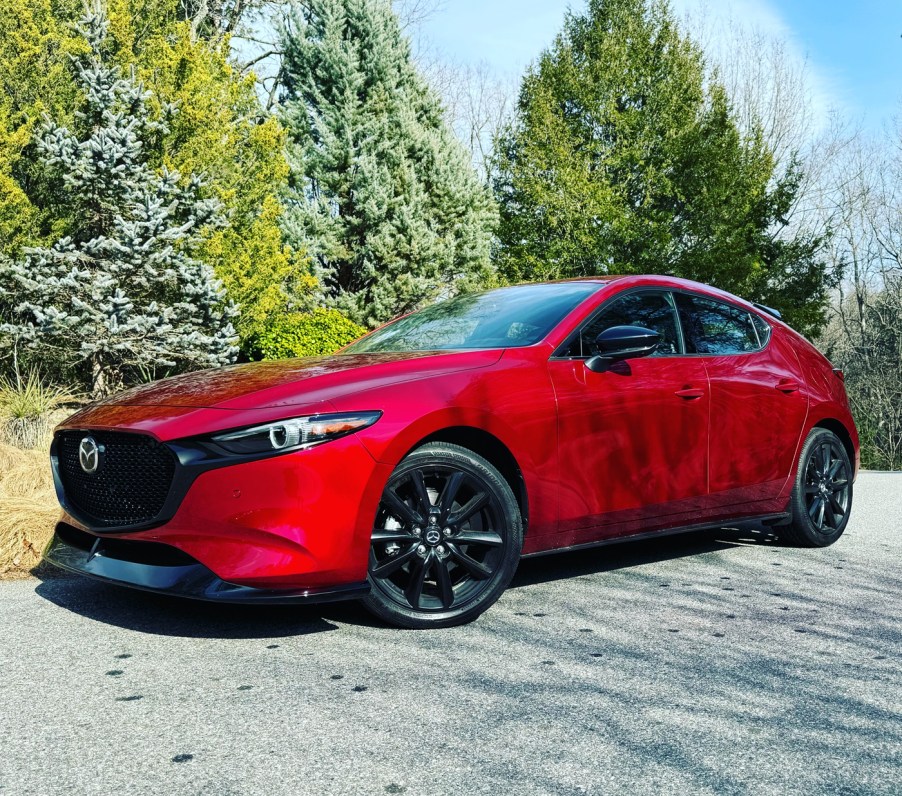 The 2024 Mazda3 Turbo Premium Plus parked near evergreen trees