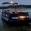 A Sea-Doo Switch Cruise Limited pontoon boat shows off its mood lighting.