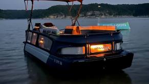 A Sea-Doo Switch Cruise Limited pontoon boat shows off its mood lighting.