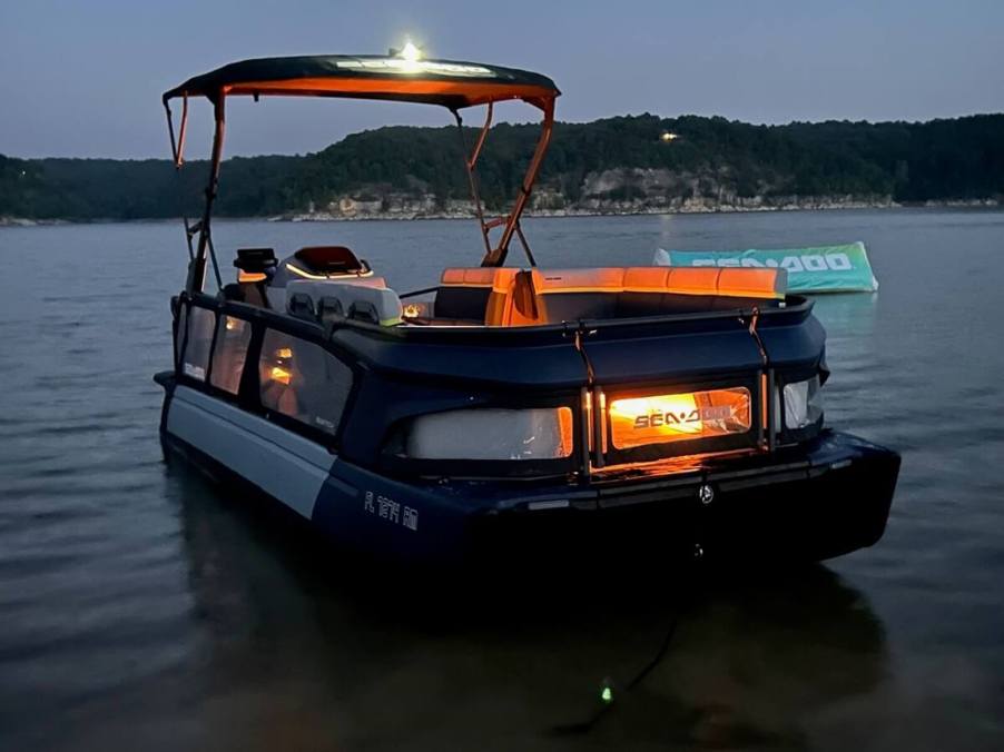 A Sea-Doo Switch Cruise Limited pontoon boat shows off its mood lighting.